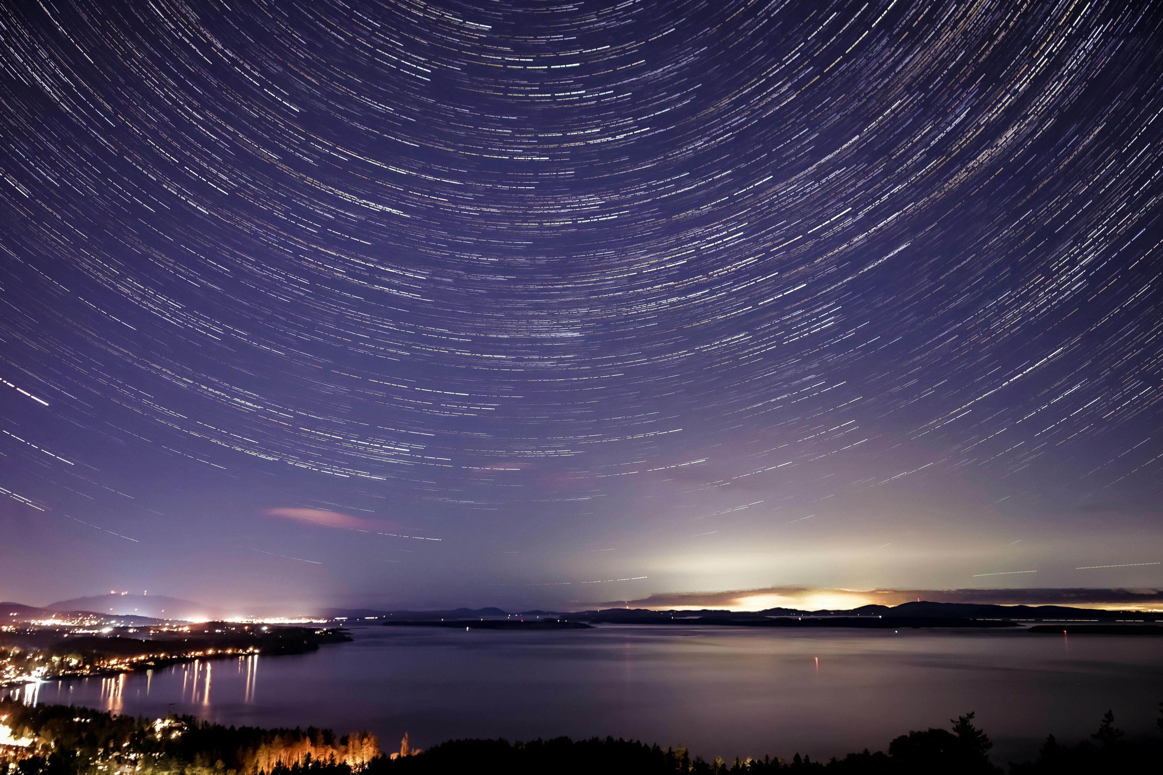 Glowing Lights Of City On Seashore Under Starry Sky - free abstract HD wallpaper